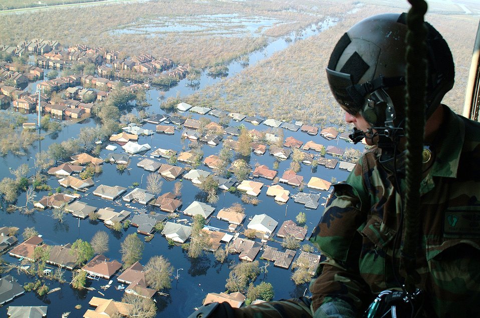 Tech. Sgt. Keith Berry looks down into flooded streets searching for survivors. He is part of an Air Force Reserve team credited with saving more than 1,040 people in the aftermath of Hurricane Katrina. 